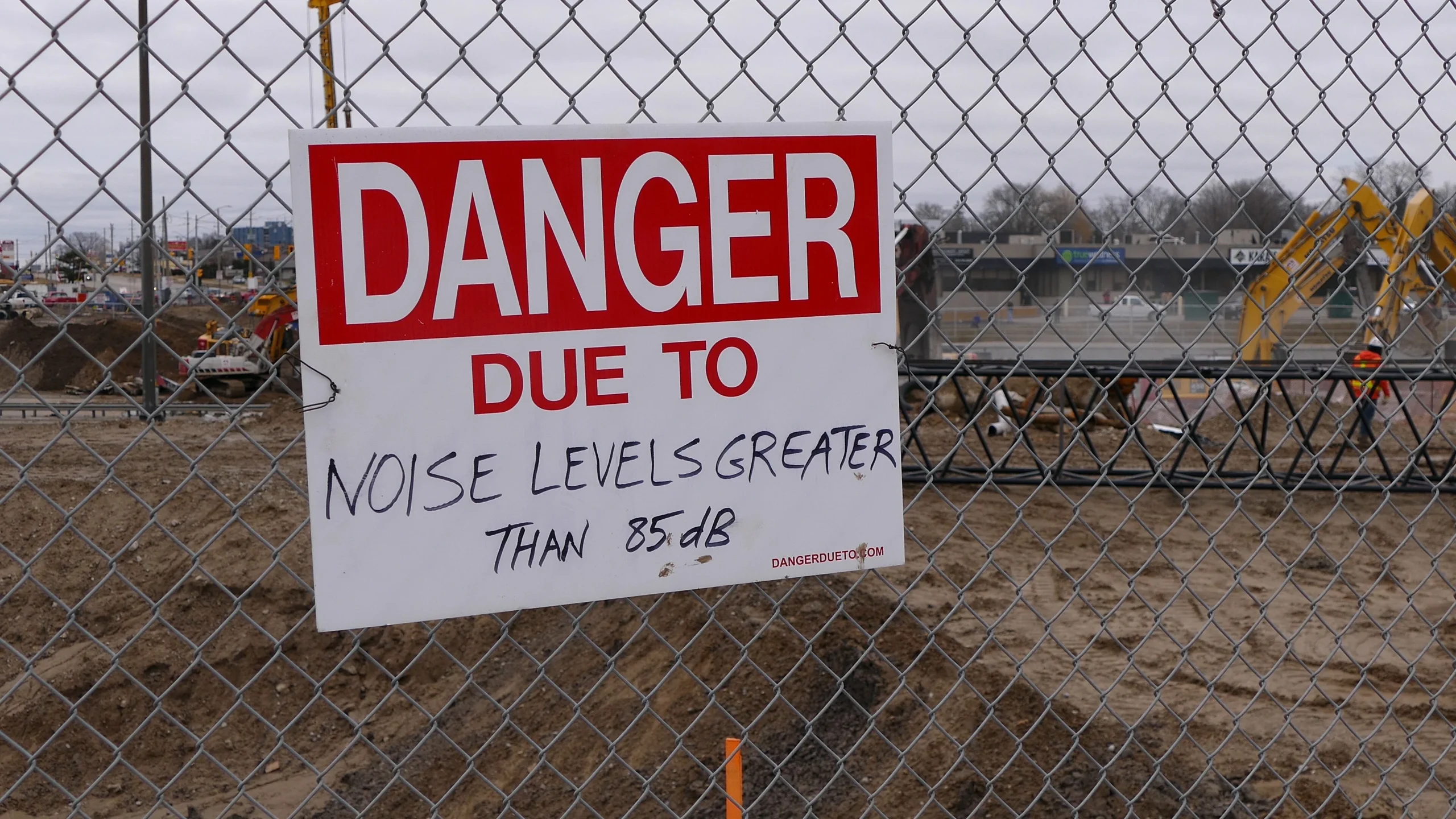 Construction site danger sign representing noise from construction activity